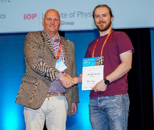   Dr Christopher Benjamin, ASTeC receiving a best poster prize